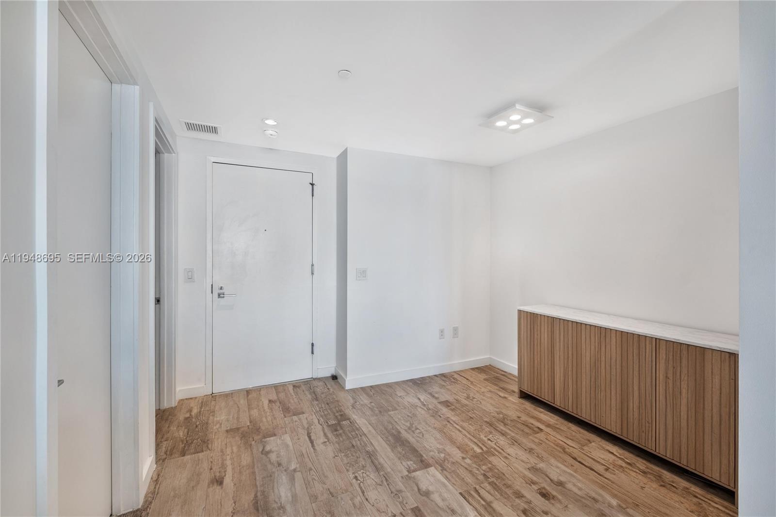 650 Northeast 32nd Street, Unit 4306 Miami, FL 33137 - Photo 26 of 52 a view of an empty room with wooden floor and a window