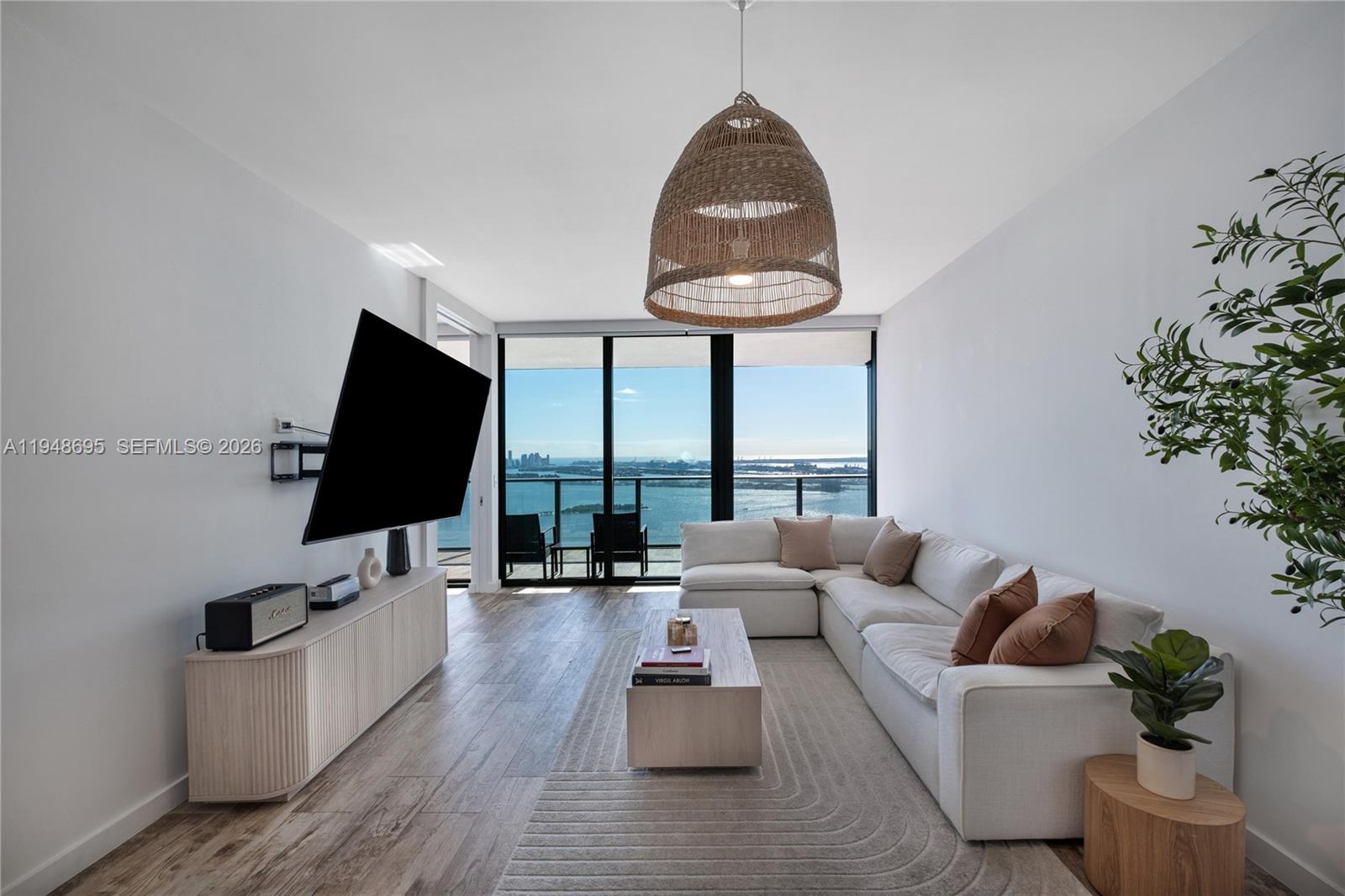 650 Northeast 32nd Street, Unit 4306 Miami, FL 33137 - Photo 3 of 52 a living room with furniture and a flat screen tv