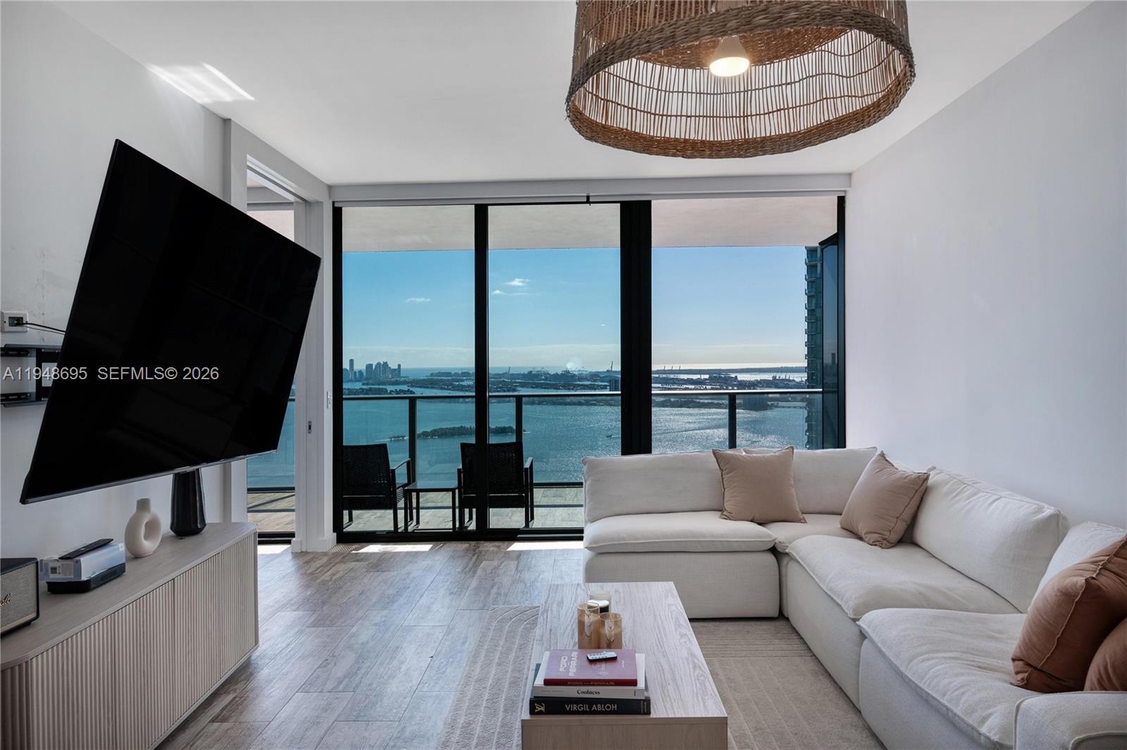 650 Northeast 32nd Street, Unit 4306 Miami, FL 33137 - Photo 5 of 52 a living room with furniture and a flat screen tv