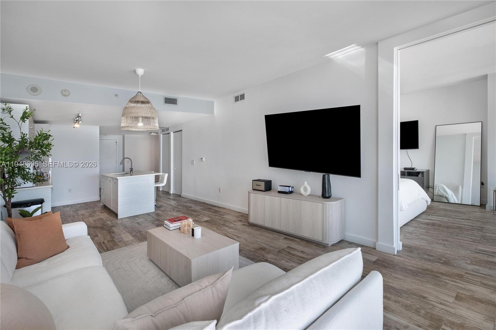 650 Northeast 32nd Street, Unit 4306 Miami, FL 33137 - Photo 6 of 52 a living room with furniture and a flat screen tv