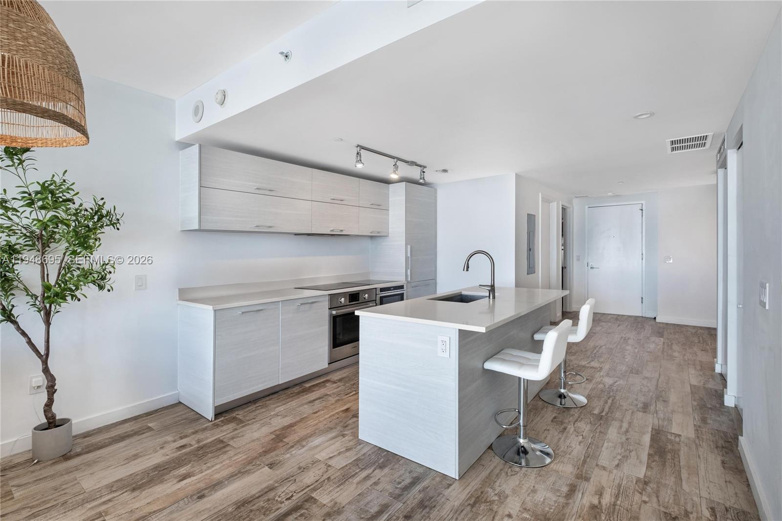 650 Northeast 32nd Street, Unit 4306 Miami, FL 33137 - Photo 10 of 52 a kitchen with a sink and cabinets