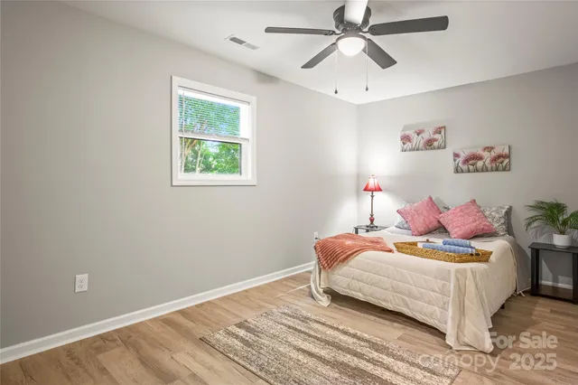 a bedroom with a bed and a potted plant