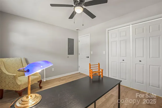 a living room with furniture and a kitchen view