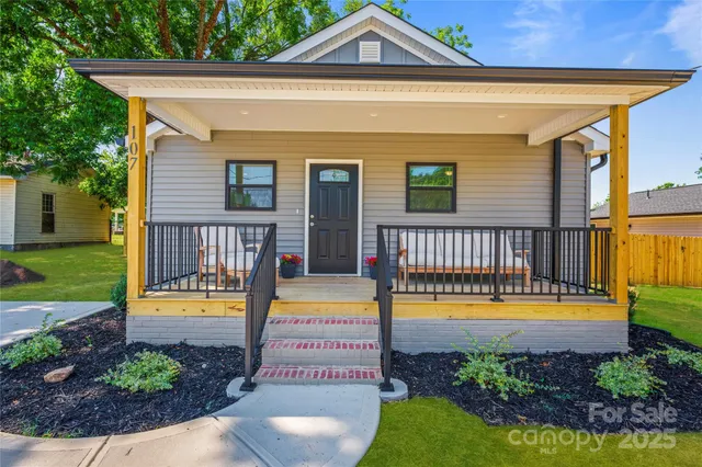 a view of a swimming pool with a lounge chairs and a small yard