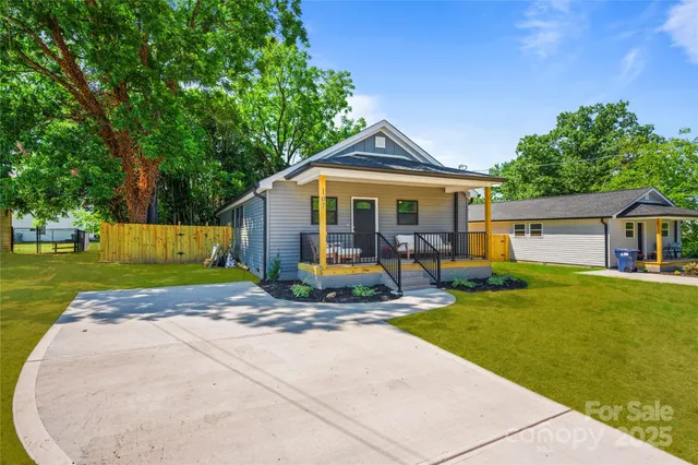 a view of a house with backyard sitting area and garden