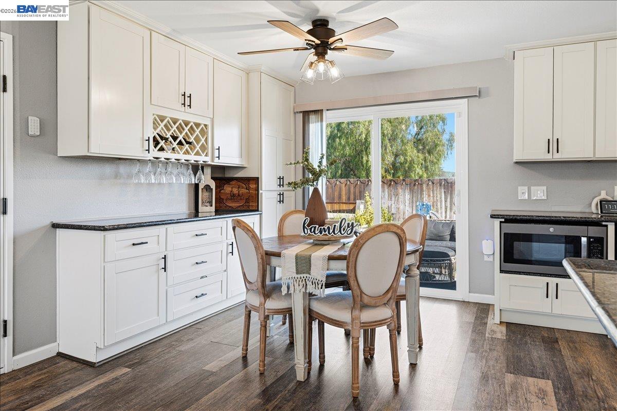 1279 Marigold Road Livermore, CA 94551 - Photo 12 of 53 a dining room with furniture a chandelier and wooden floor