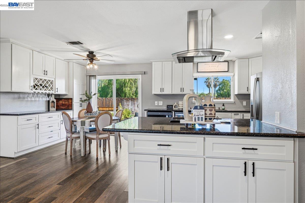 1279 Marigold Road Livermore, CA 94551 - Photo 19 of 53 a kitchen with stainless steel appliances a white table chairs refrigerator and cabinets