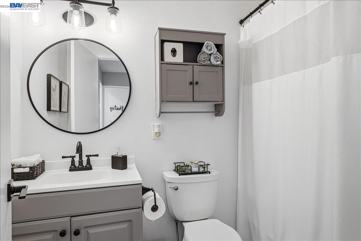 1279 Marigold Road Livermore, CA 94551 - Photo 27 of 53 a bathroom with a sink mirror and toilet