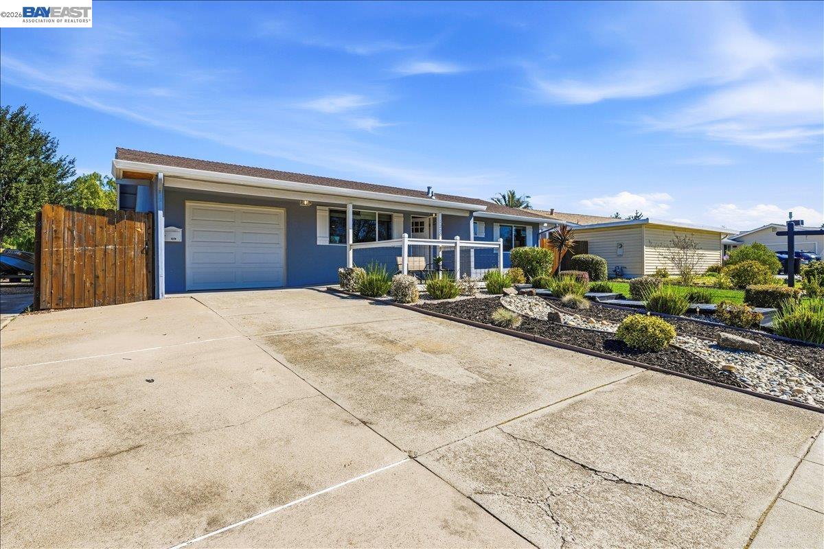 1279 Marigold Road Livermore, CA 94551 - Photo 4 of 53 a view of a house with potted plants and a car