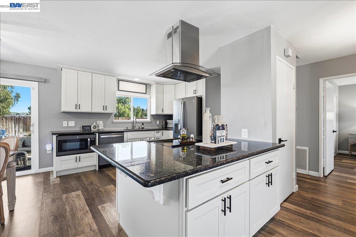 1279 Marigold Road Livermore, CA 94551 - Photo 7 of 53 a kitchen with stainless steel appliances granite countertop a sink stove and refrigerator