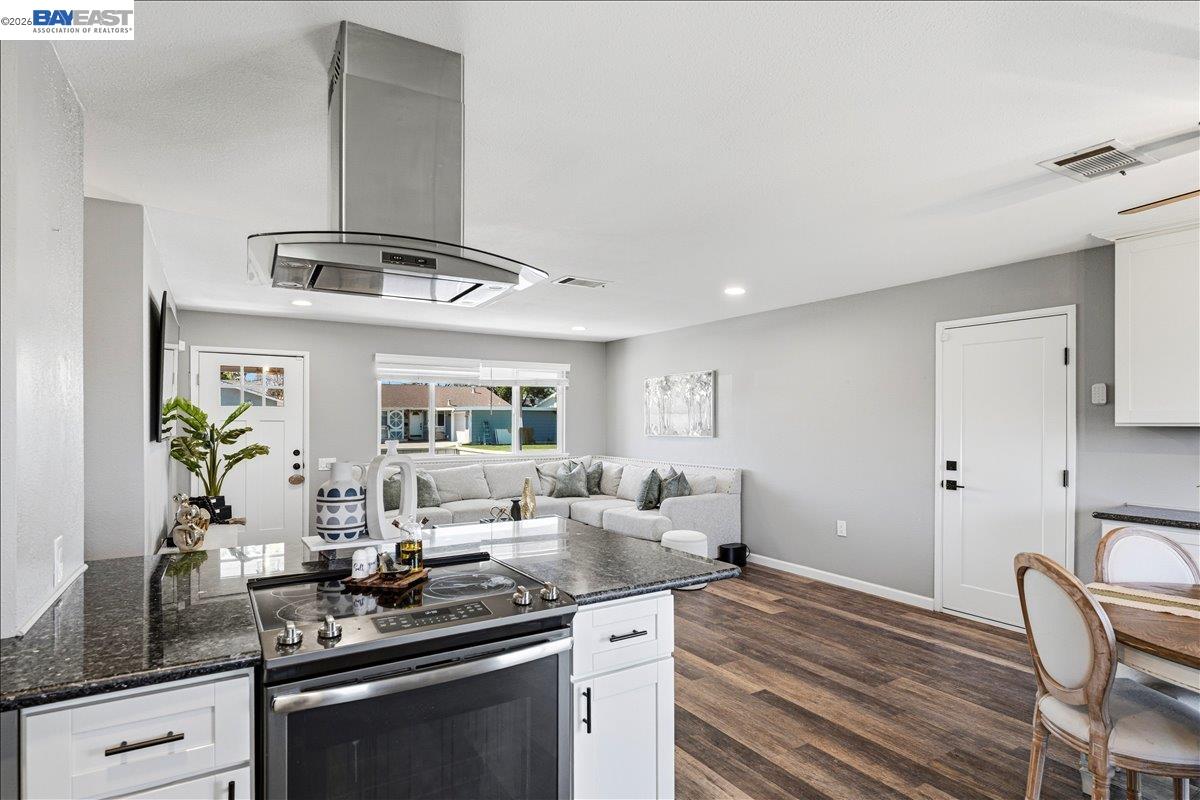 1279 Marigold Road Livermore, CA 94551 - Photo 9 of 53 a kitchen with stainless steel appliances granite countertop a stove and white cabinets