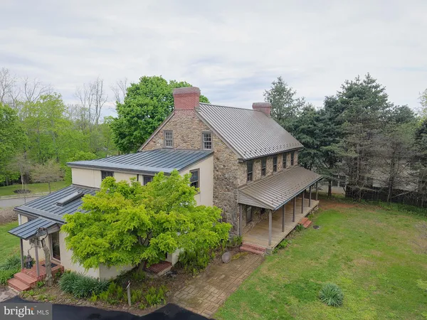an aerial view of a house with garden space and street view