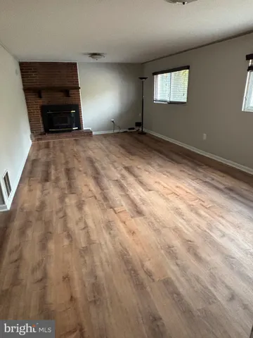 a view of empty room with a fireplace