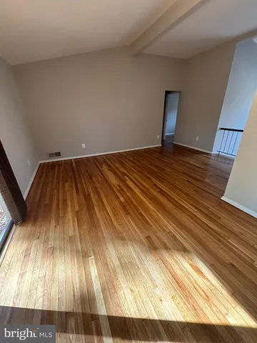 a view of a room with wooden floor