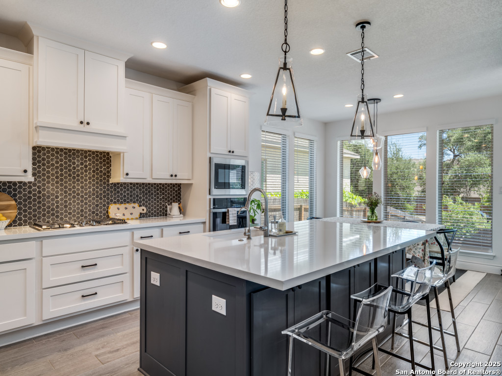 25902 Madison Ranch San Antonio, TX 78255 - Photo 13 of 36 a kitchen with a sink stove and cabinets