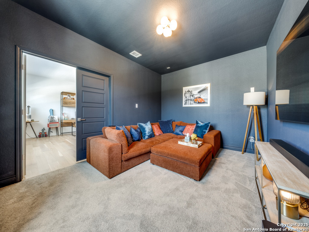 25902 Madison Ranch San Antonio, TX 78255 - Photo 23 of 36 a living room with furniture and a flat screen tv