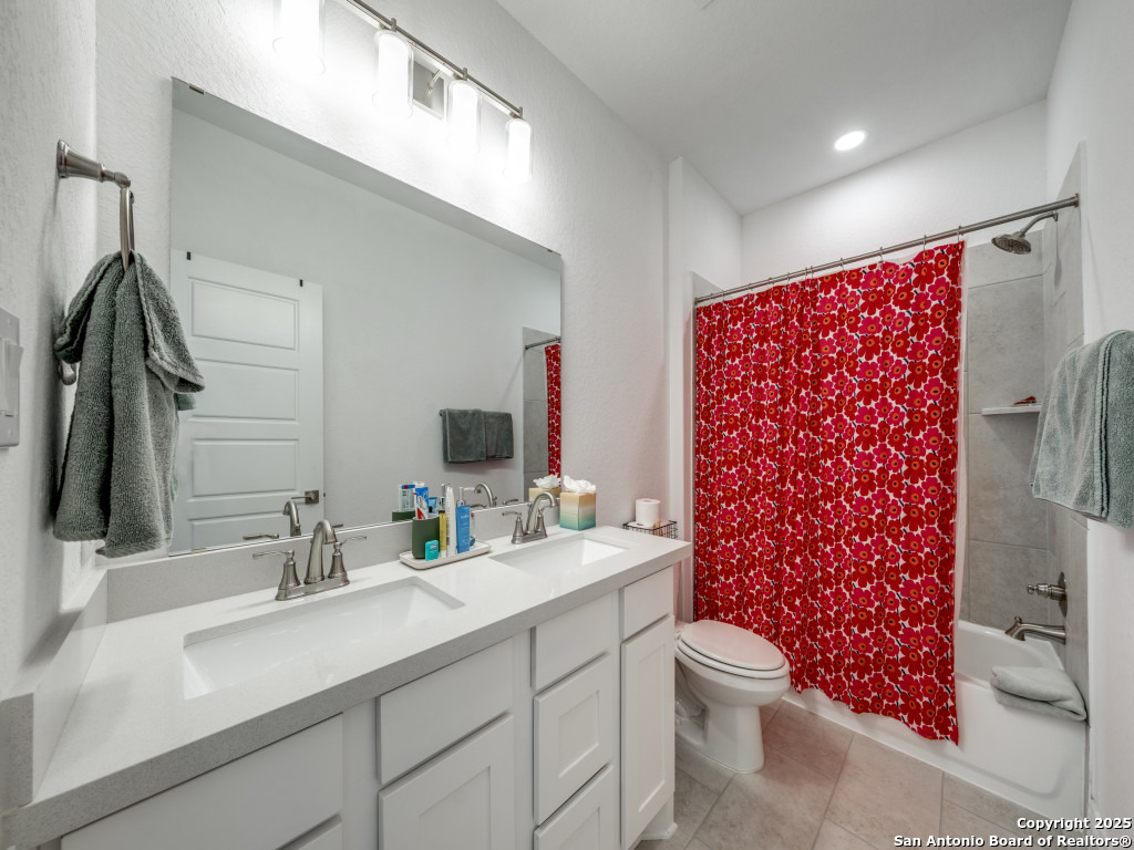 25902 Madison Ranch San Antonio, TX 78255 - Photo 26 of 36 a bathroom with a double vanity sink toilet and shower