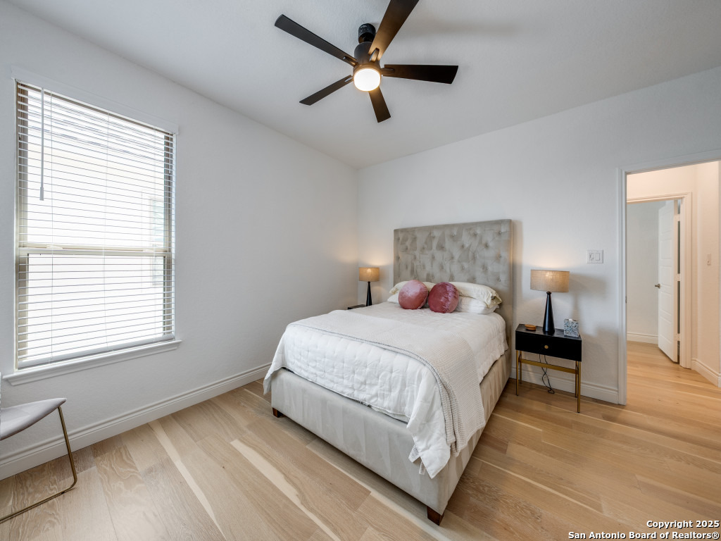 25902 Madison Ranch San Antonio, TX 78255 - Photo 27 of 36 a bedroom with a bed and a ceiling fan