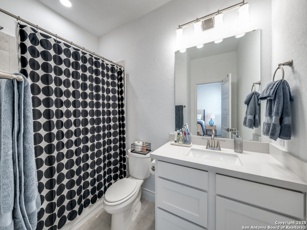 25902 Madison Ranch San Antonio, TX 78255 - Photo 31 of 36 a bathroom with a sink a toilet a shower and a mirror
