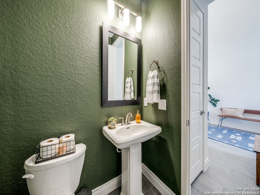 25902 Madison Ranch San Antonio, TX 78255 - Photo 7 of 36 a bathroom with a toilet sink and mirror