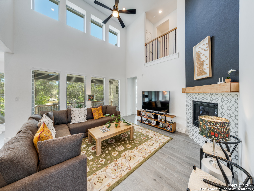 25902 Madison Ranch San Antonio, TX 78255 - Photo 10 of 36 a living room with furniture a flat screen tv and a fireplace