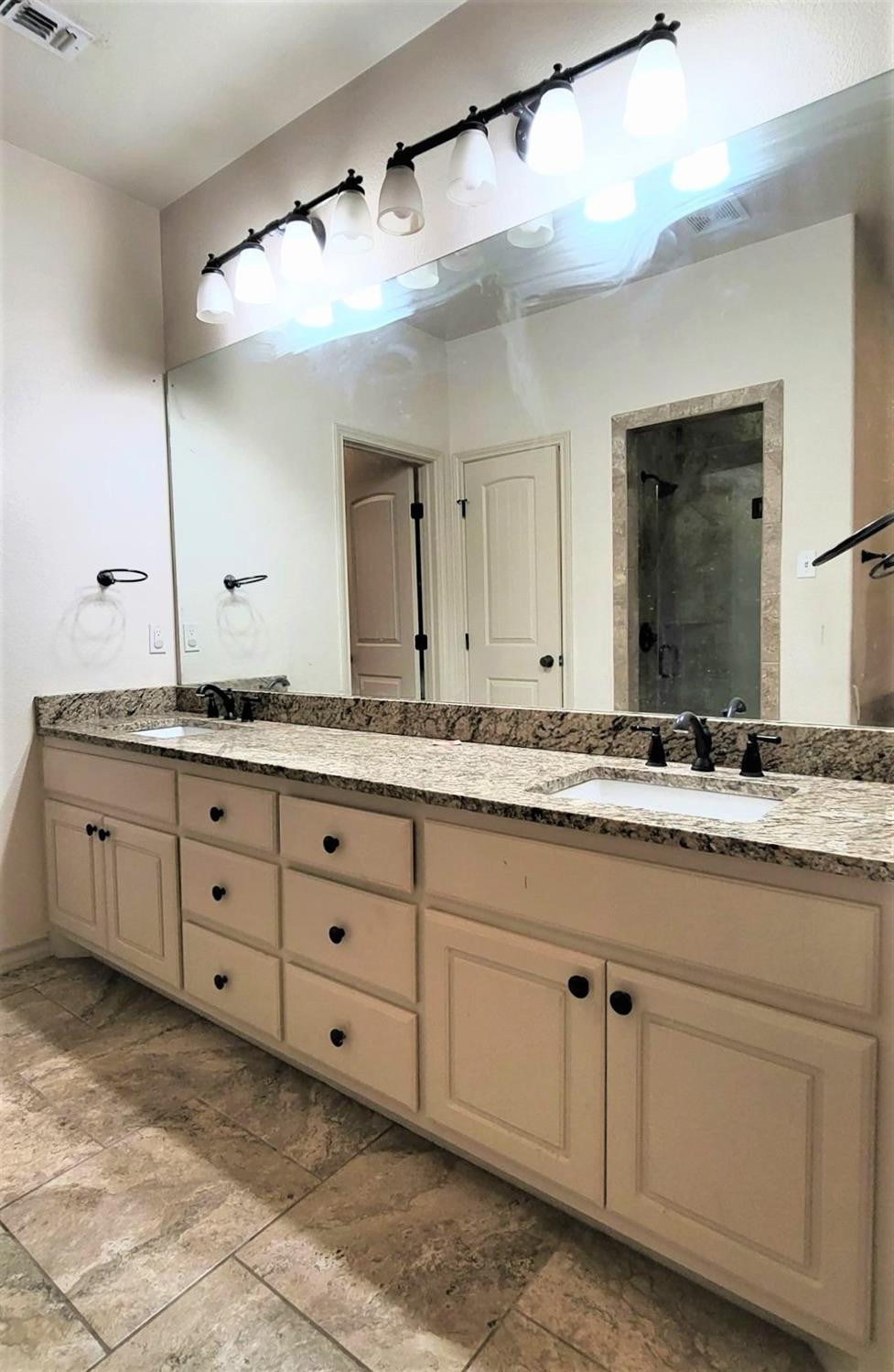 5234 Kemper Street Lubbock, TX 79416 - Photo 12 of 28 a bathroom with a granite countertop sink and mirror