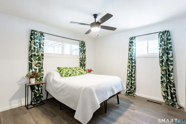 a bedroom with a bed and a window