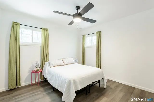 a bedroom with a large bed and a chandelier