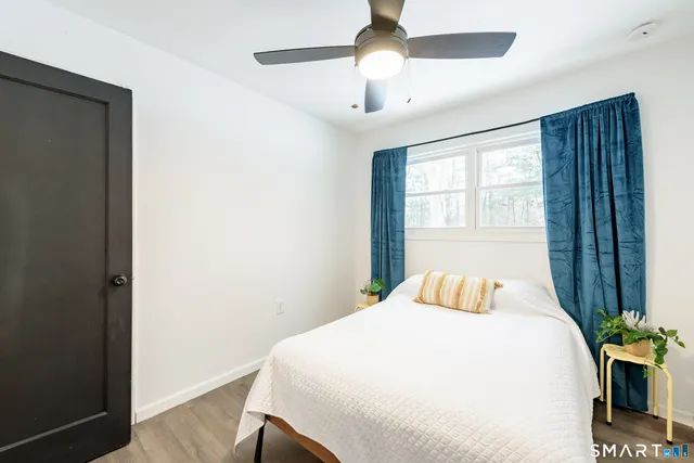 a bedroom with a bed and a window