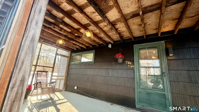a front view of a house with a yard covered in snow