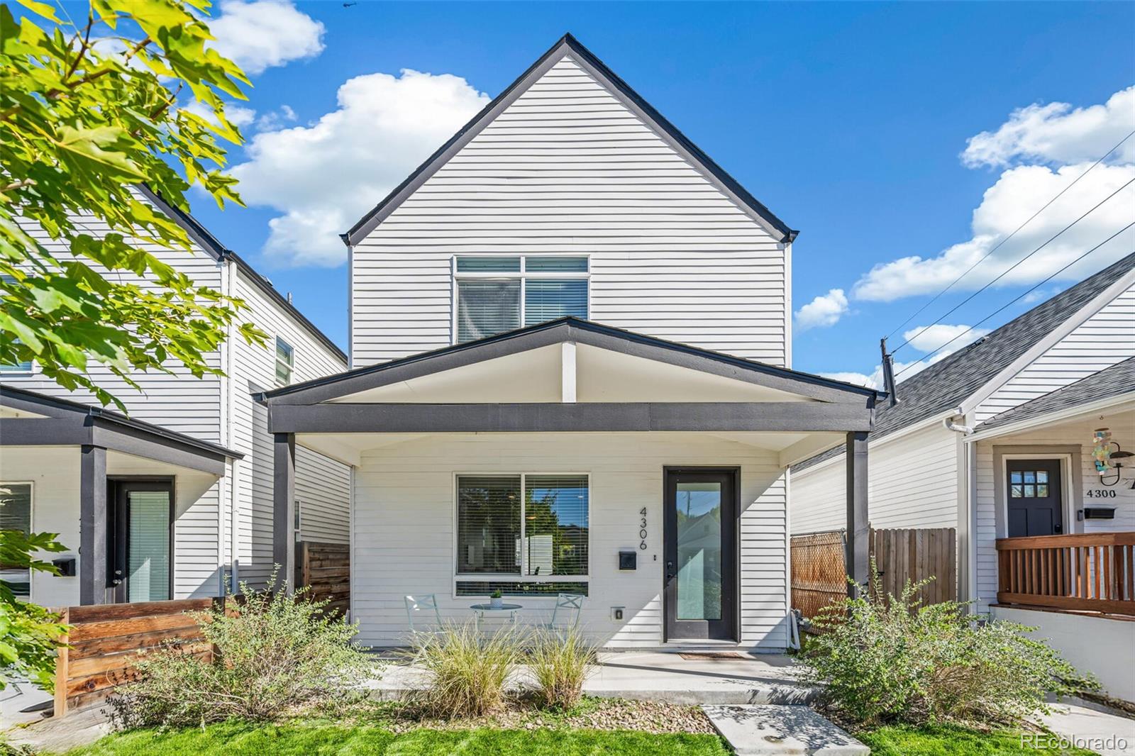 front view of a house with potted plants