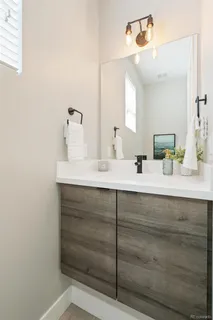 a bathroom with a sink vanity and mirror