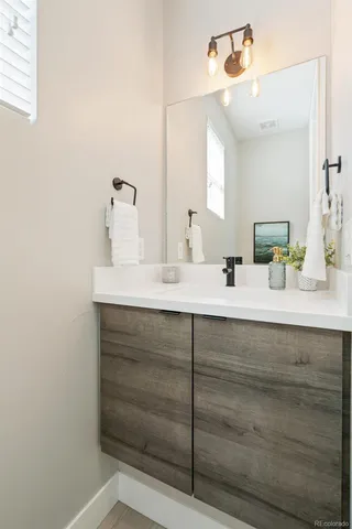 a bathroom with a sink vanity and mirror