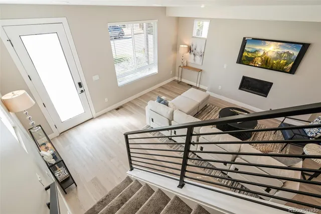 a view of an empty room with wooden floor