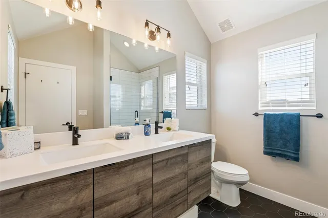 a bathroom with a sink mirror and a toilet