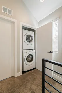 a utility room with sink dryer and washer
