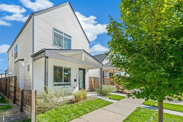 a front view of a house with garden and porch