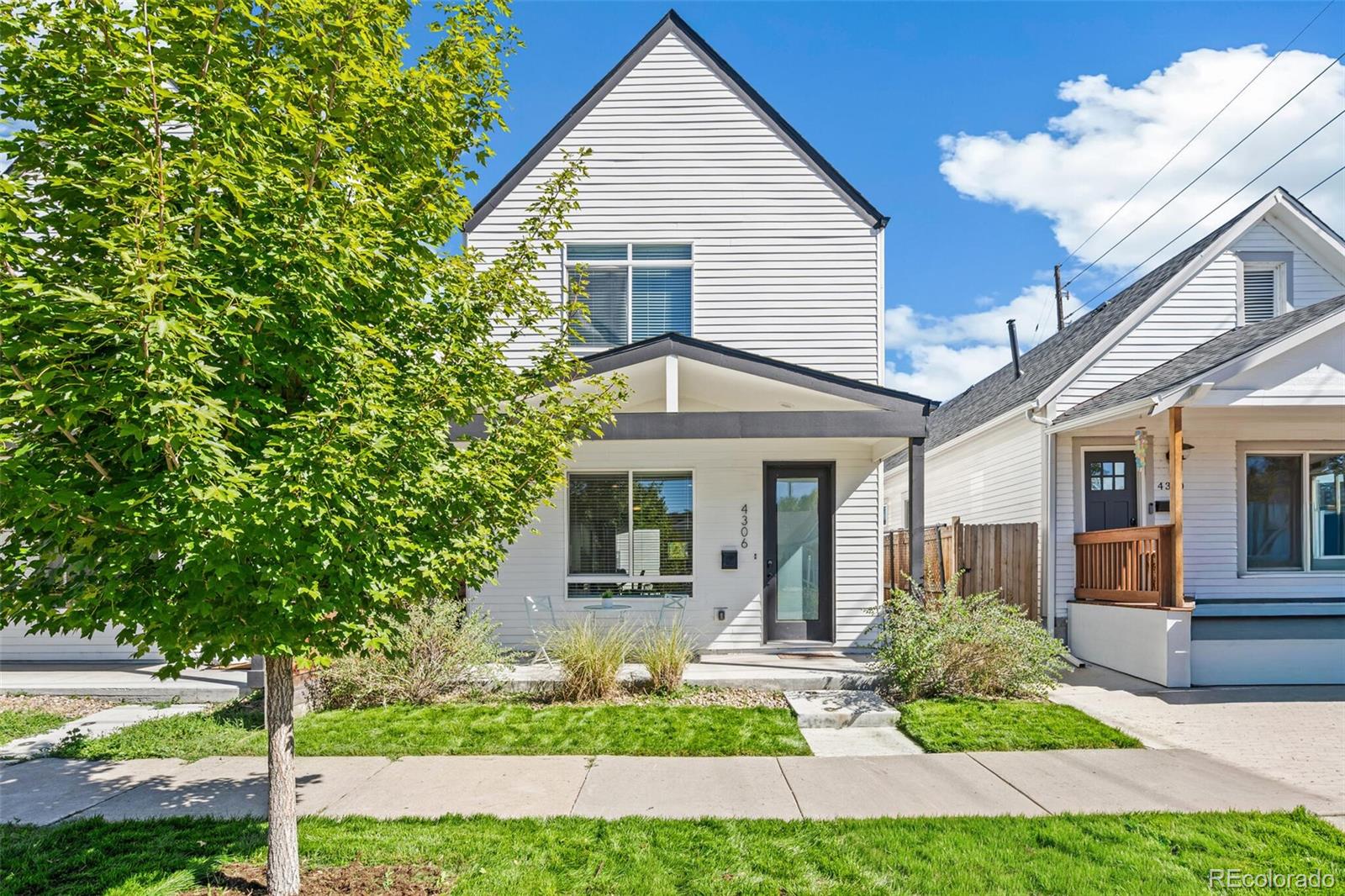 4306 Sherman Street Denver, CO 80216 - Photo 28 of 32 a front view of a house with garden