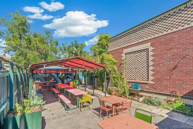 a view of a patio with a table and chairs under an umbrella