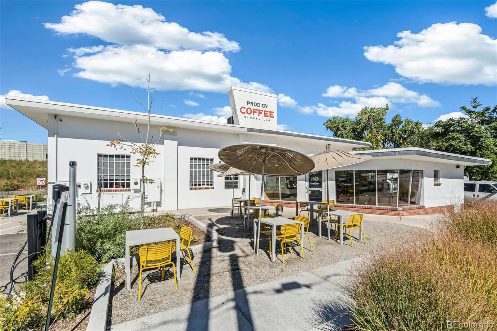 4306 Sherman Street Denver, CO 80216 - Photo 31 of 32 a view of a patio with table and chairs under an umbrella