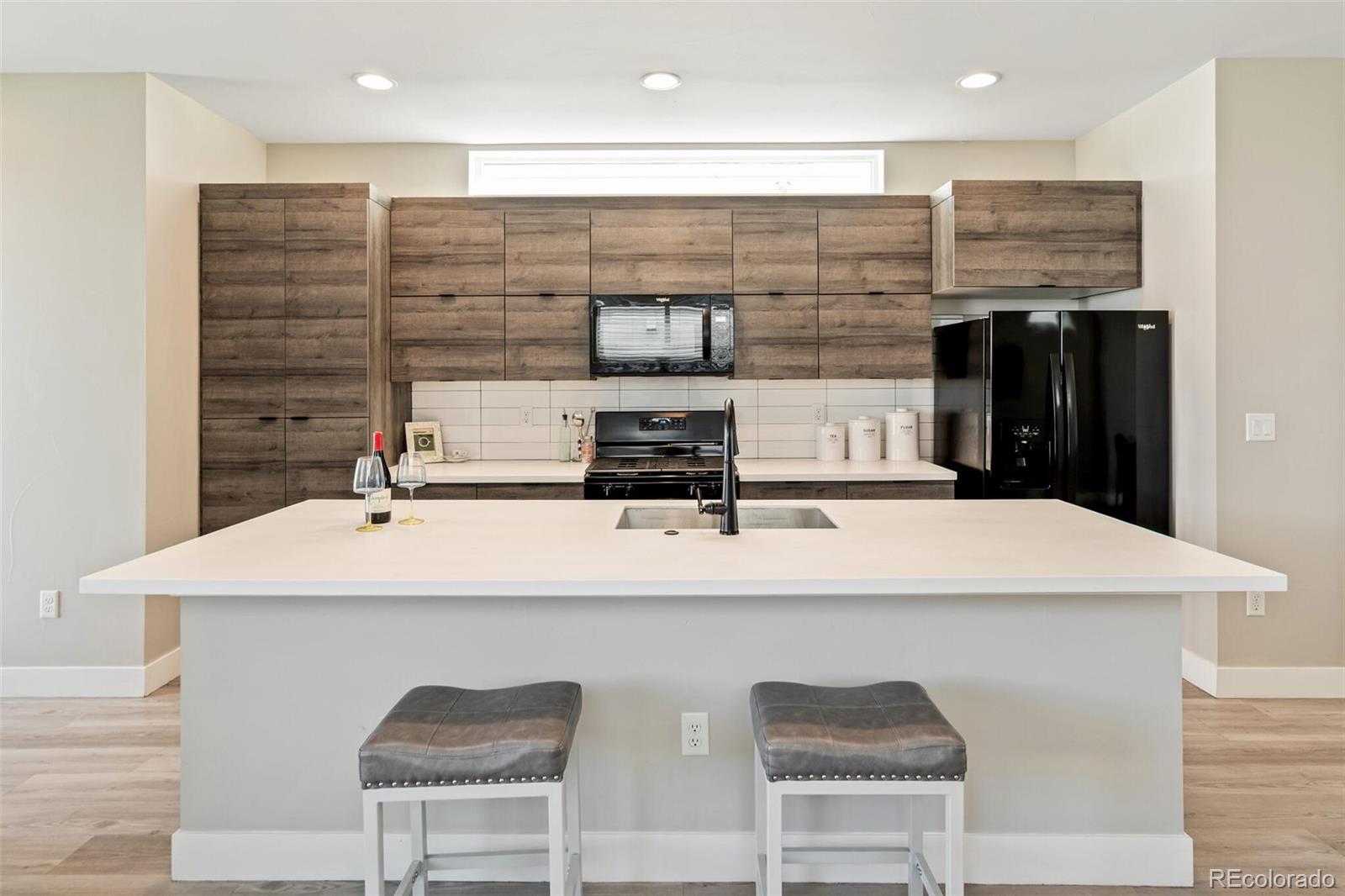 4306 Sherman Street Denver, CO 80216 - Photo 8 of 32 a kitchen with a sink and cabinets