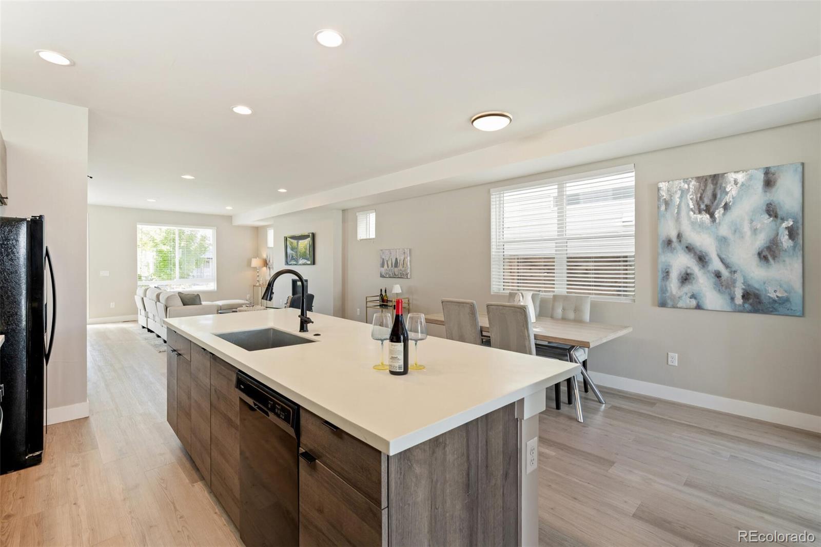 4306 Sherman Street Denver, CO 80216 - Photo 10 of 32 a kitchen with center island and sink