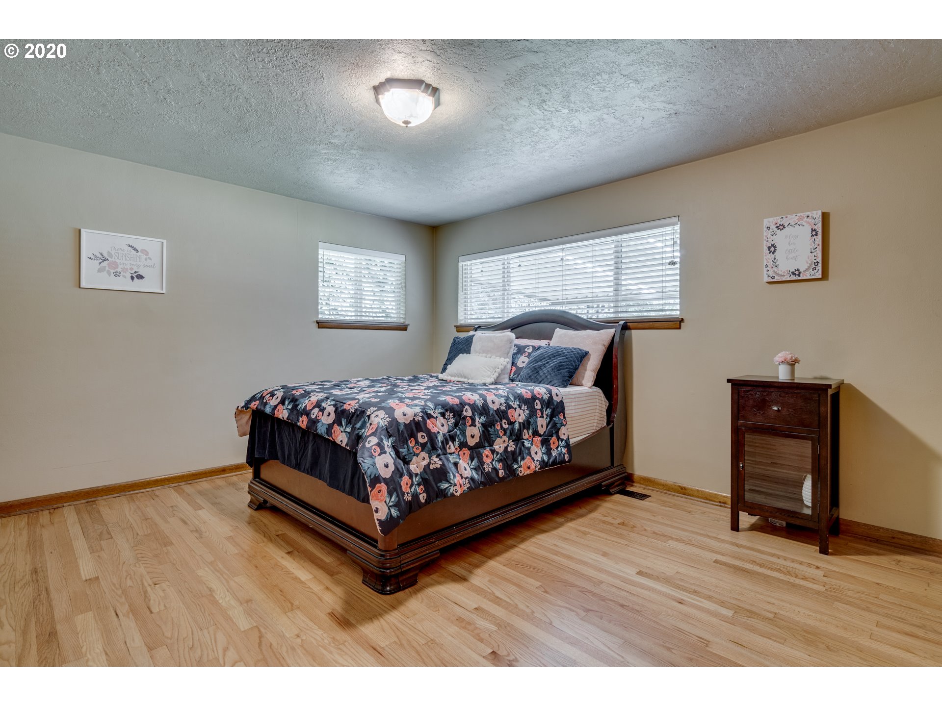 18400 Southeast Richey Road Gresham, OR 97080 - Photo 20 of 32 a bed sitting in a bedroom next to a window with a bookshelf