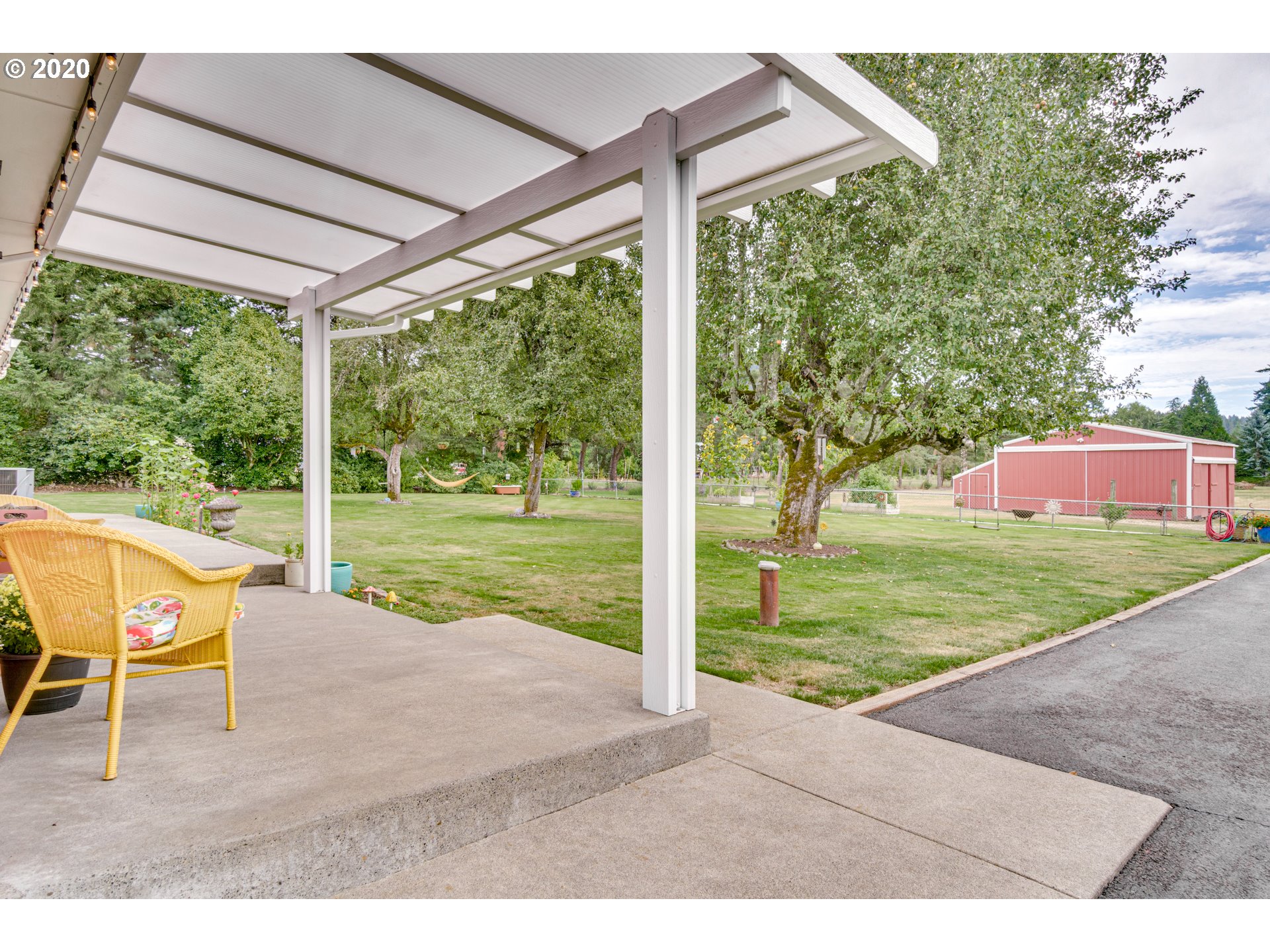 18400 Southeast Richey Road Gresham, OR 97080 - Photo 24 of 32 a view of a patio with table and chairs potted plants and a big yard