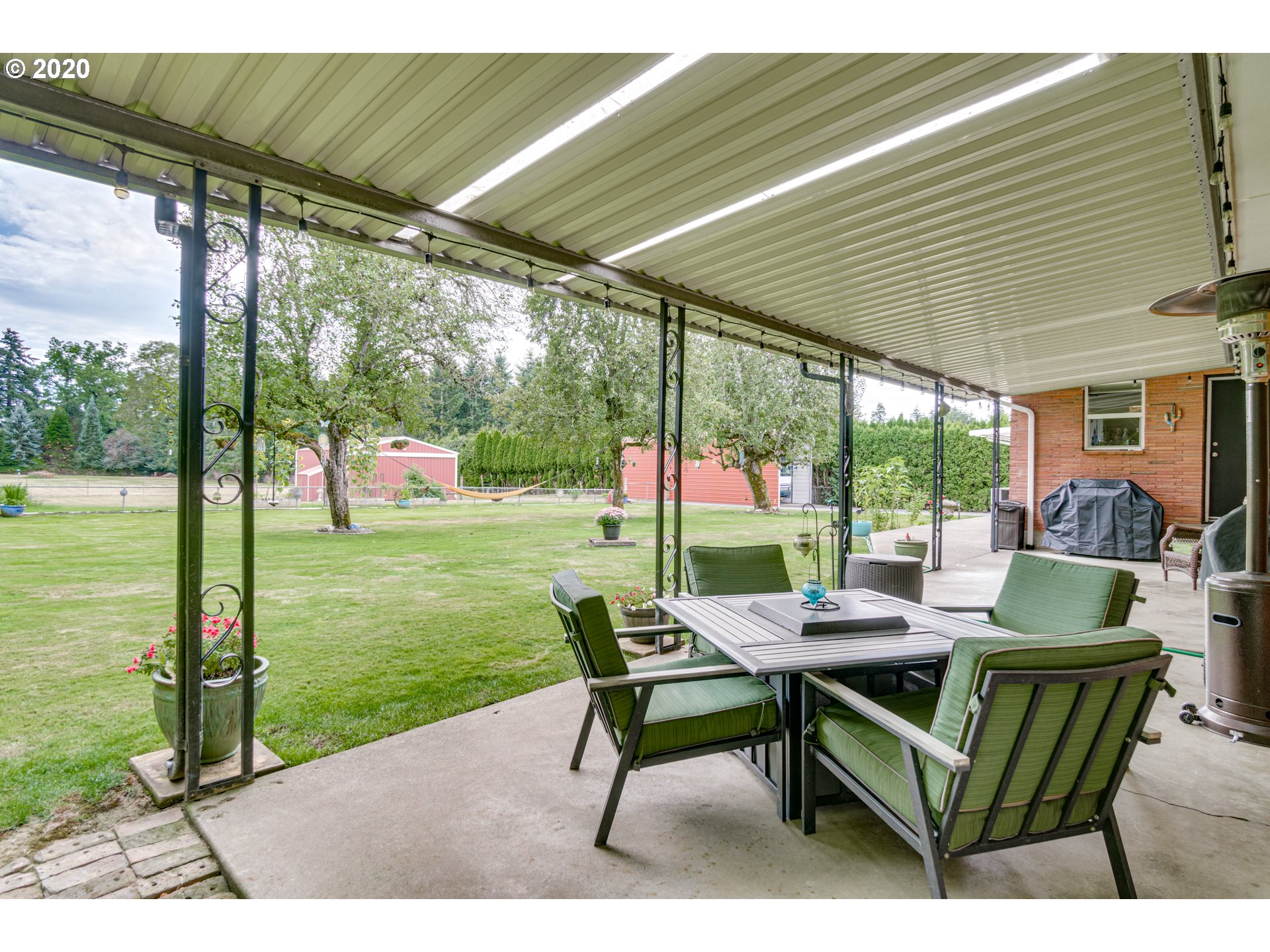 18400 Southeast Richey Road Gresham, OR 97080 - Photo 25 of 32 a view of a patio with a table chairs and a backyard