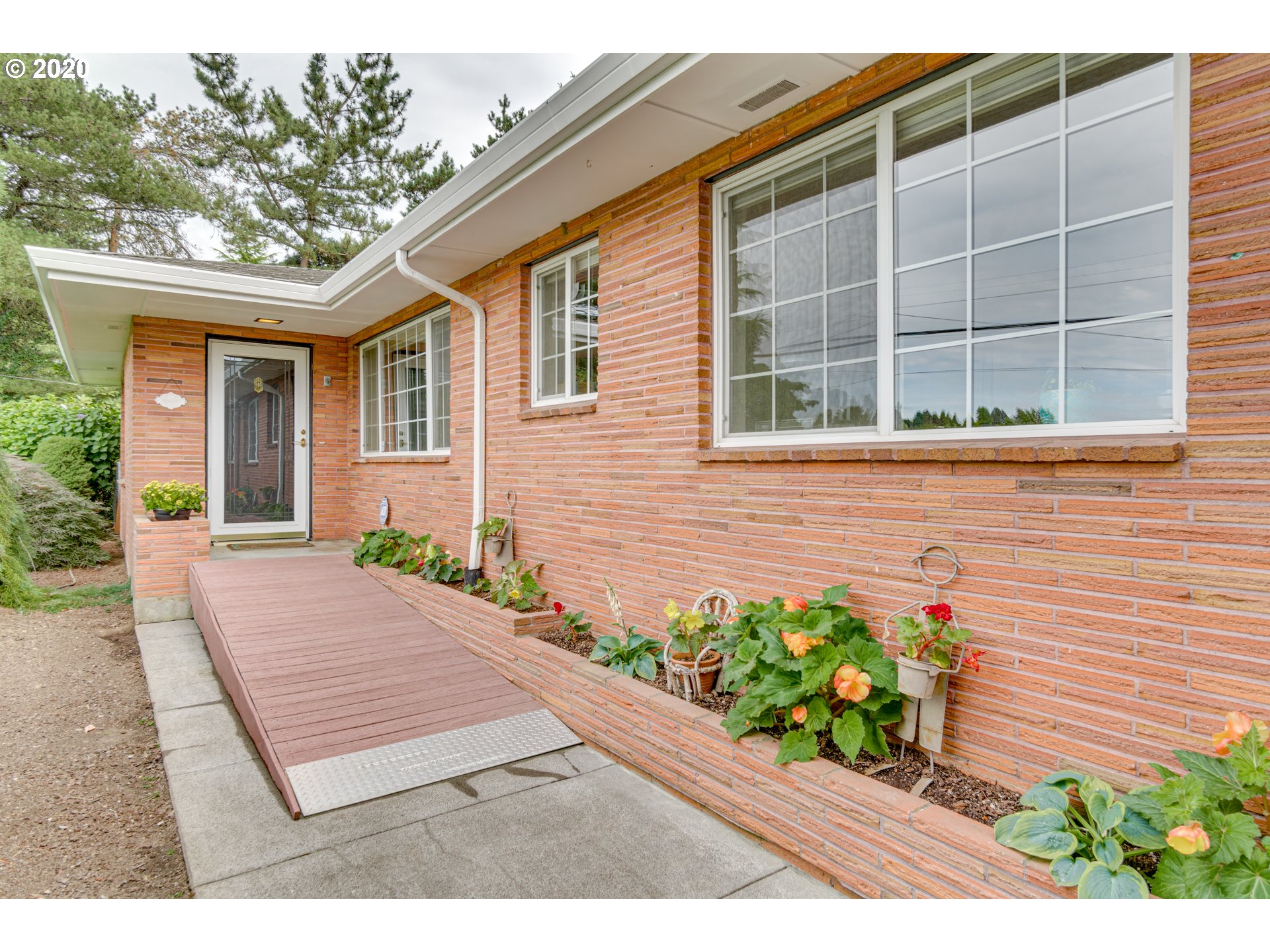 18400 Southeast Richey Road Gresham, OR 97080 - Photo 3 of 32 a view of a house with a small yard and flower plants