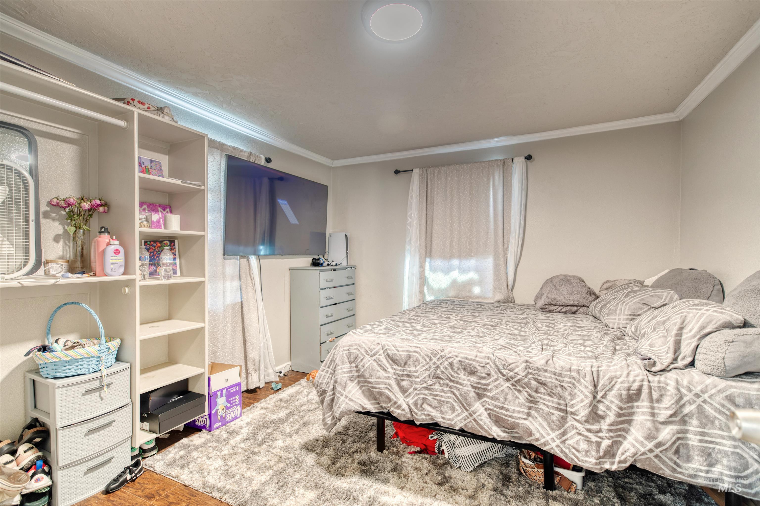106 East Main Street Nyssa, OR 97913 - Photo 11 of 32 Bedroom with ornamental molding and wood finished floors