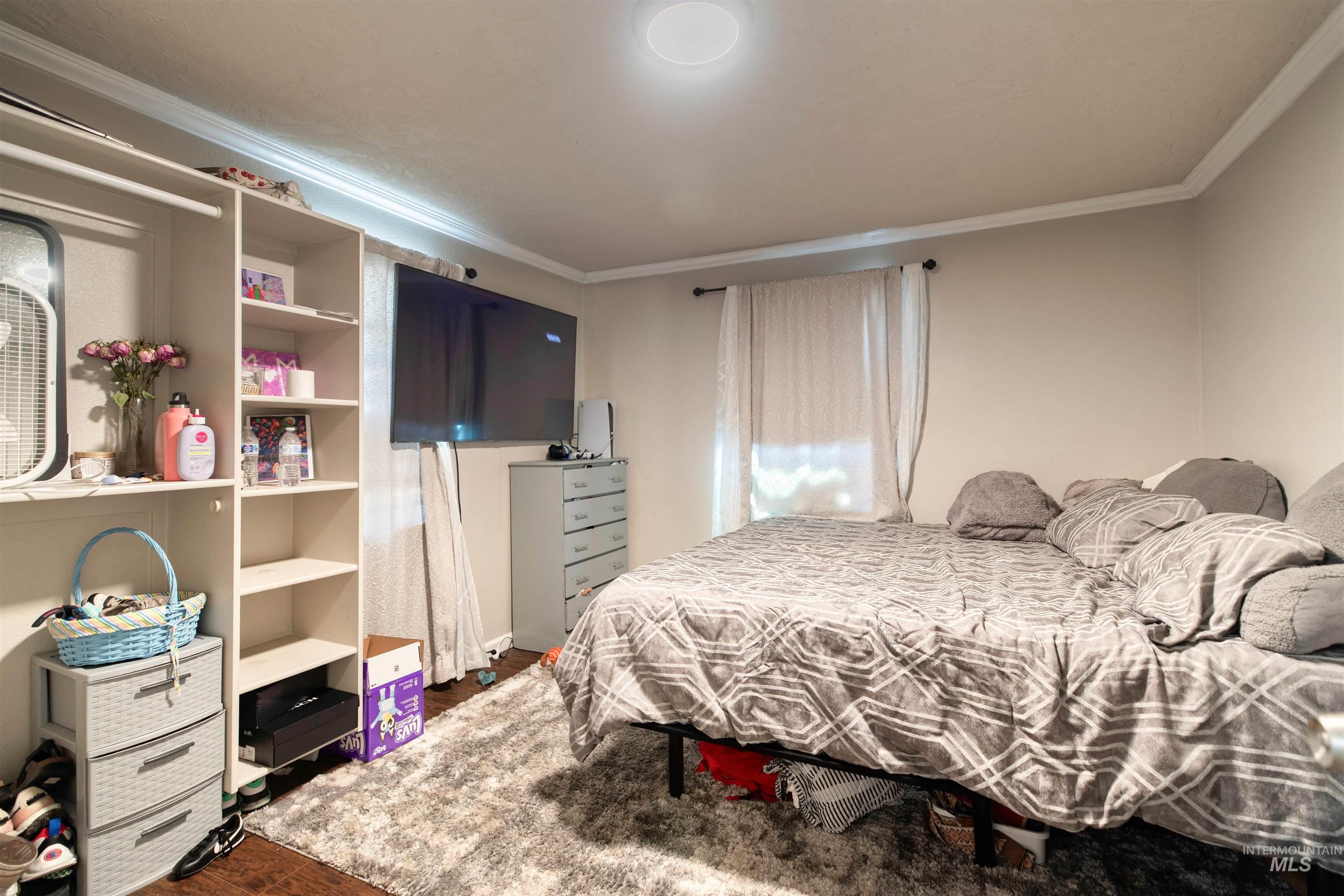 106 East Main Street Nyssa, OR 97913 - Photo 10 of 32 Bedroom featuring ornamental molding and dark wood-style flooring