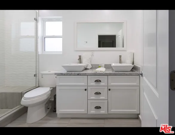 a bathroom with a sink toilet and mirror