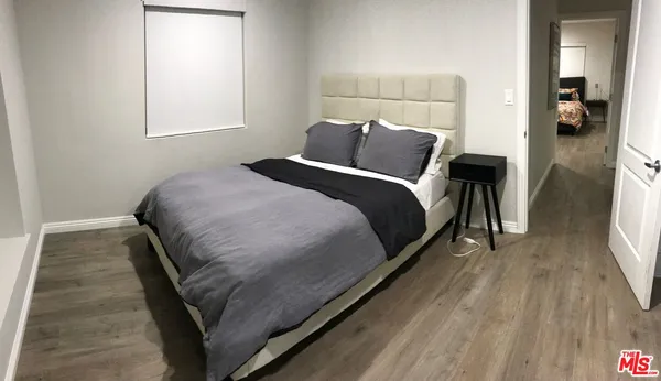 a bedroom with a bed and a mirror